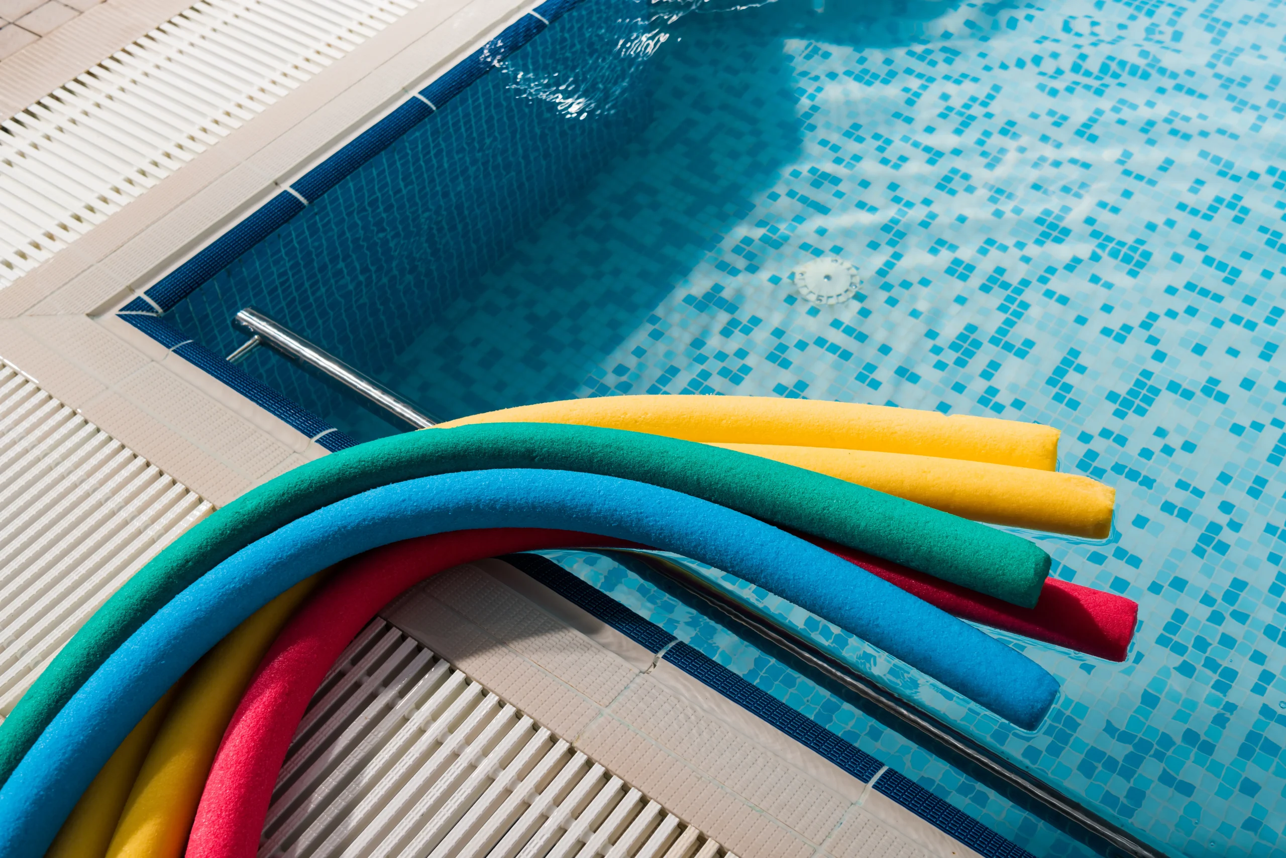 top view of colorful pool noodles near swimming po 2026 03 11 08 42 34 utc scaled